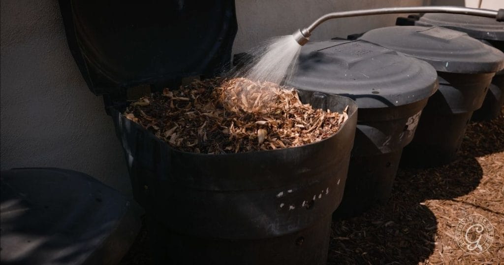 Spraying down compost